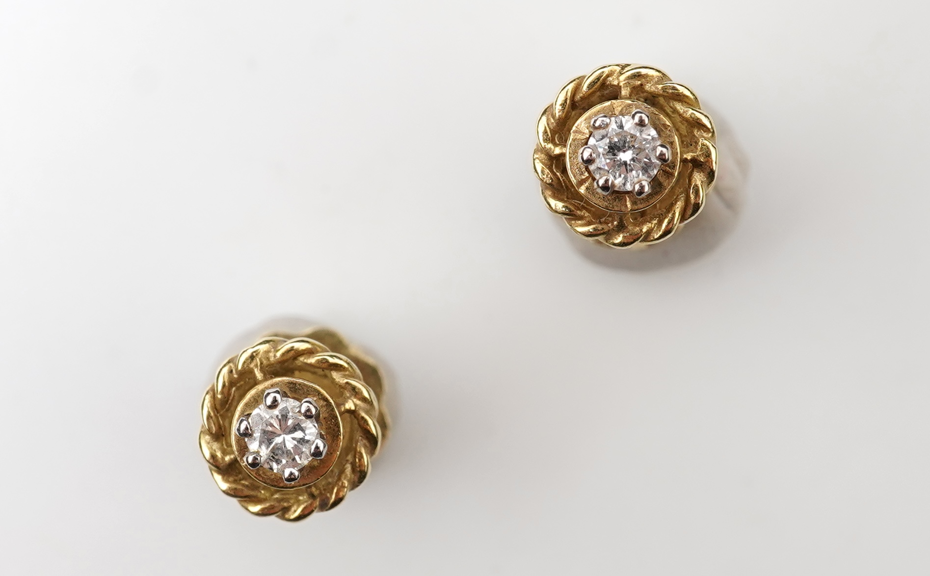 A pair of diamond stud earrings